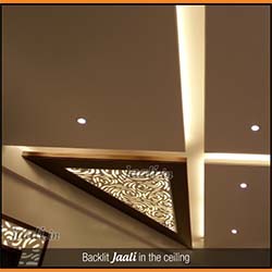 Neatly placed backlit MDF Jaali in the ceiling having curves in the design which breaks the monotony of straight lines